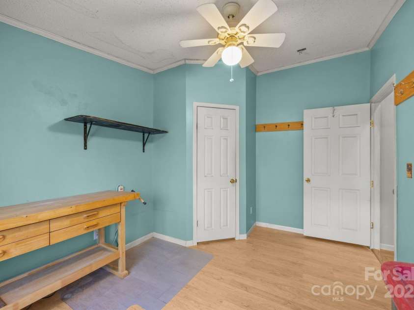74 Davis Chapel Road, Candler, NC 28715.  MLS# CAR4311937, YatesRealty ID 1457. Third bedroom used as a workshop