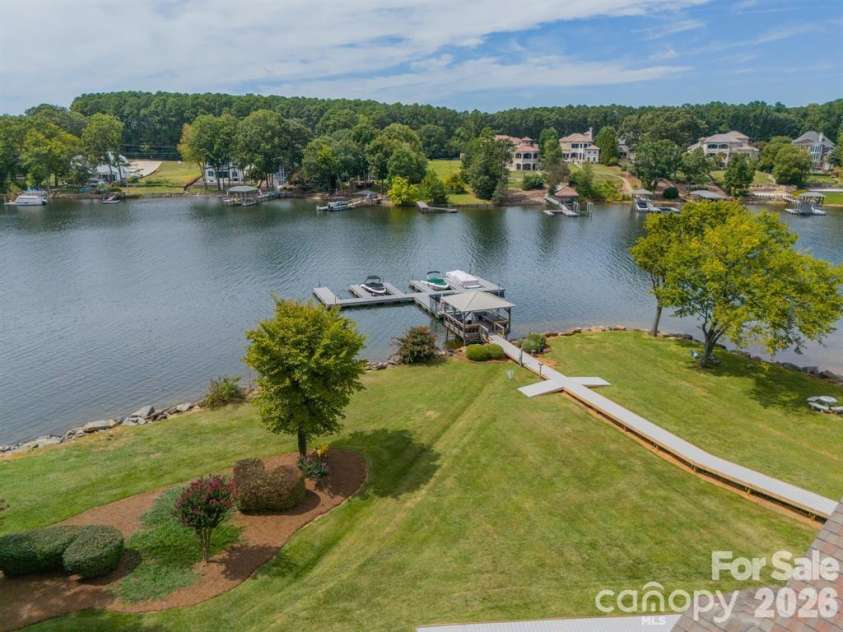 7822 Village Harbor Drive, Cornelius, NC 28031.  MLS# CAR4351828, YatesRealty ID 14578. Community Day Dock.  This includes some privately owned slips, plus a place for residents to tie up while they run up to their condo to pick up more lake fun supplies ... or have a friend pick you up in THEIR boa