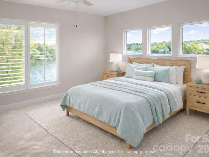7822 Village Harbor Drive, Cornelius, NC 28031.  MLS# CAR4351828, YatesRealty ID 14578. Hmm ... mm ... mm. If this doesn't make you wake up in a good mood, I don't know what will. This light-filled primary bedroom features large windows that frame serene water views, bringing in abundant natural lig