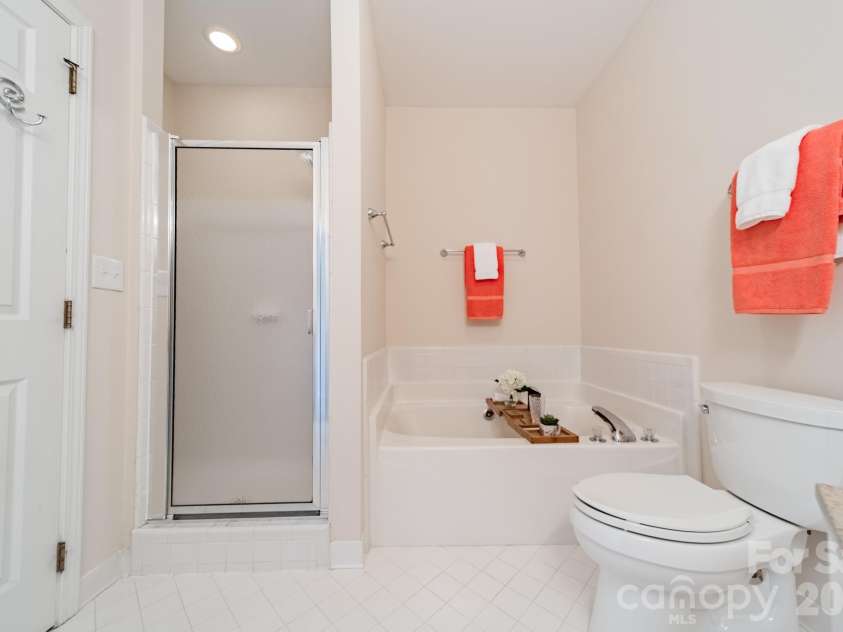 7822 Village Harbor Drive, Cornelius, NC 28031.  MLS# CAR4351828, YatesRealty ID 14578. Primary bath has an updated shower plus a mind-soothing soaking tub ... relax ...