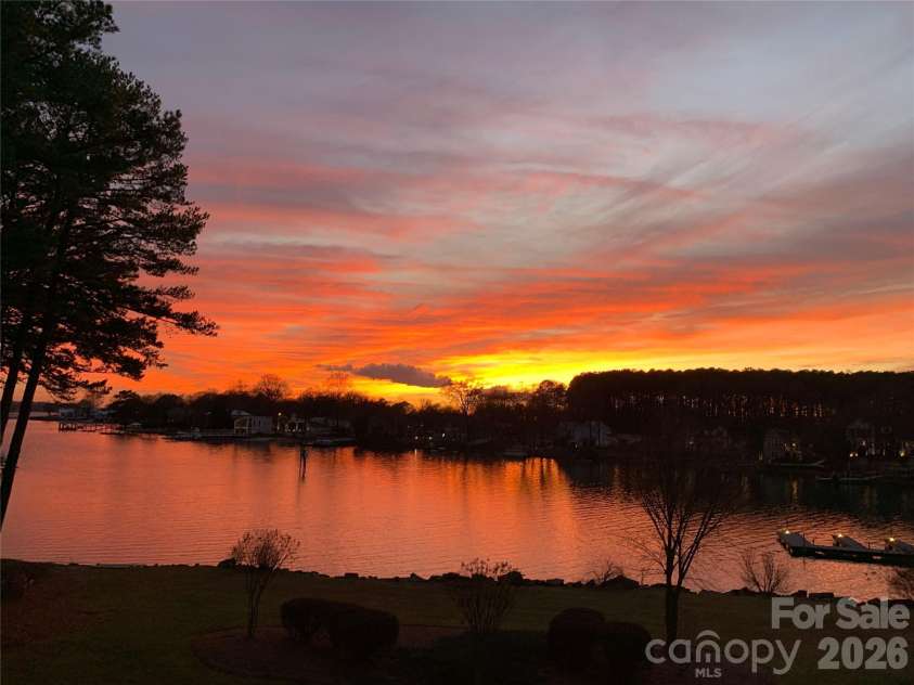 7822 Village Harbor Drive, Cornelius, NC 28031.  MLS# CAR4351828, YatesRealty ID 14578. Stunning sunset views over the lake. Enjoy peaceful water vistas, colorful evening skies, and a relaxing lakeside setting from this desirable waterfront community. Perfect for those seeking a low-maintenance life