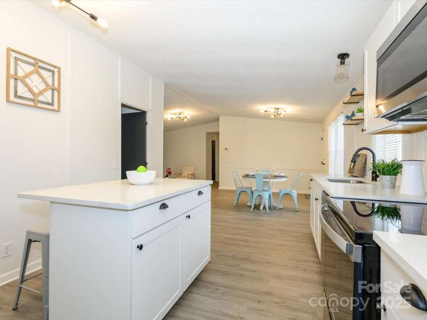 105 Mountain Brook Drive, Bessemer City, NC 28016.  MLS# CAR4237868, YatesRealty ID 14590. View from kitchen to rest of home.