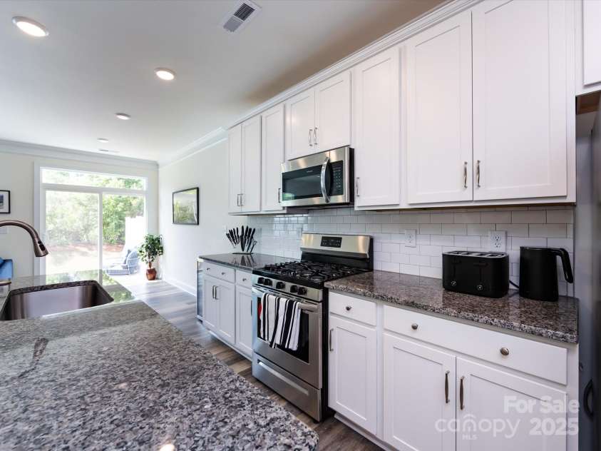 2141 Bexar Trail, Matthews, NC 28105.  MLS# CAR4255990, YatesRealty ID 14621. Kitchen that leads to outdoor patio.
