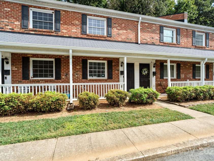 1215 Green Oaks Lane, Charlotte, NC 28205.  MLS# CAR4256711, YatesRealty ID 14622. Brick condo lives like a townhome with a private, wooded backyard.