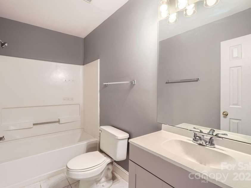 5913 Crape Myrtle Lane, Charlotte, NC 28216.  MLS# CAR4241207, YatesRealty ID 14647. Guest bathroom with newer tile flooring.