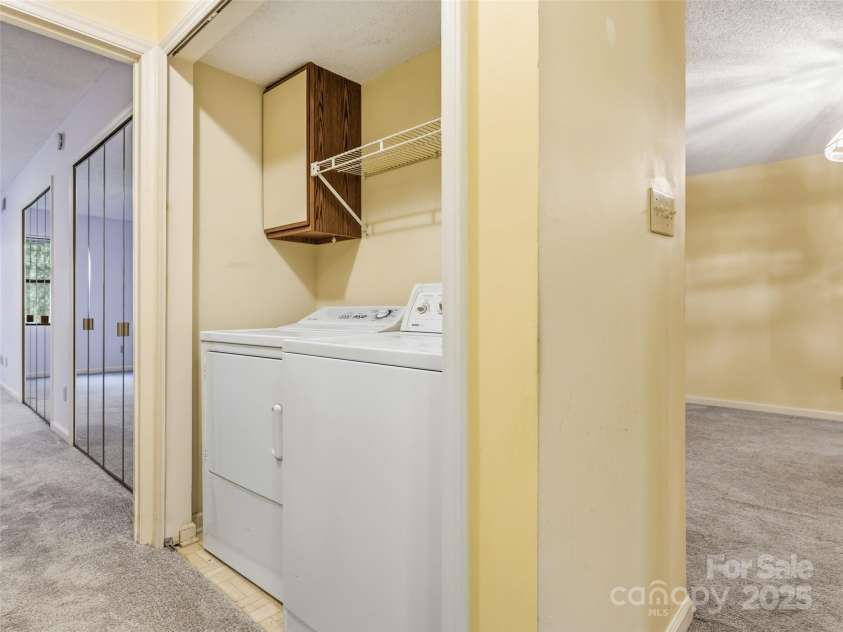 1203 Abbey Circle, Asheville, NC 28805.  MLS# CAR4315432, YatesRealty ID 14657. Hall laundry in condo
