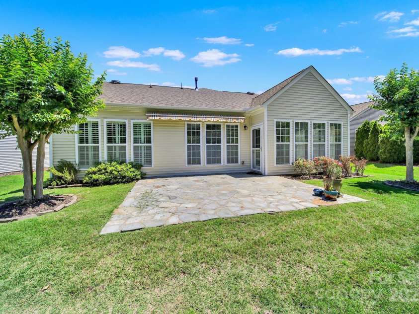 8107 Crater Lake Drive, Indian Land, SC 29707.  MLS# CAR4233120, YatesRealty ID 14662. Extra-large stone patio w/ retractable awning.