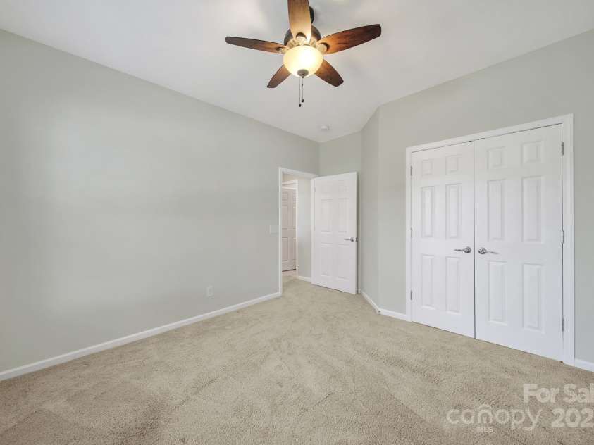 8107 Crater Lake Drive, Indian Land, SC 29707.  MLS# CAR4233120, YatesRealty ID 14662. Guest bedroom w/ ceiling fan.