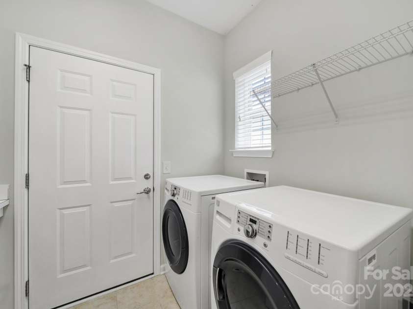 8107 Crater Lake Drive, Indian Land, SC 29707.  MLS# CAR4233120, YatesRealty ID 14662. Laundry mud room with utility sink & folding shelf.