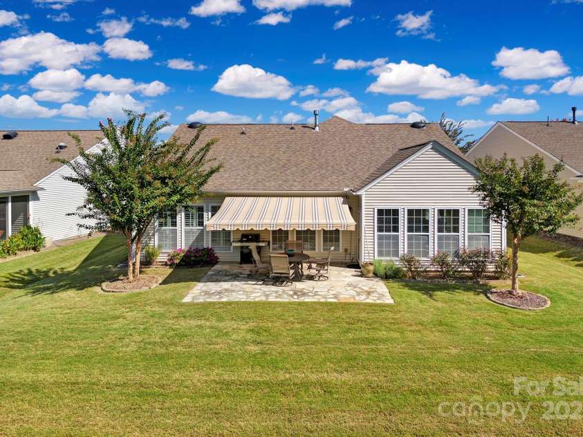 8107 Crater Lake Drive, Indian Land, SC 29707.  MLS# CAR4233120, YatesRealty ID 14662. Retractable awning over stone back patio.