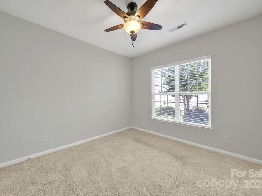 8107 Crater Lake Drive, Indian Land, SC 29707.  MLS# CAR4233120, YatesRealty ID 14662. Spacious guest bedroom at front of home, separated from primary bedroom suite.