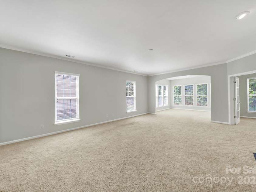 8107 Crater Lake Drive, Indian Land, SC 29707.  MLS# CAR4233120, YatesRealty ID 14662. Windows galore overlooking wooded back yard.