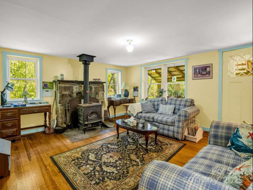 51 Moffitt Road, Horse Shoe, NC 28742.  MLS# CAR4257739, YatesRealty ID 14674. Living Room with wood burning stove