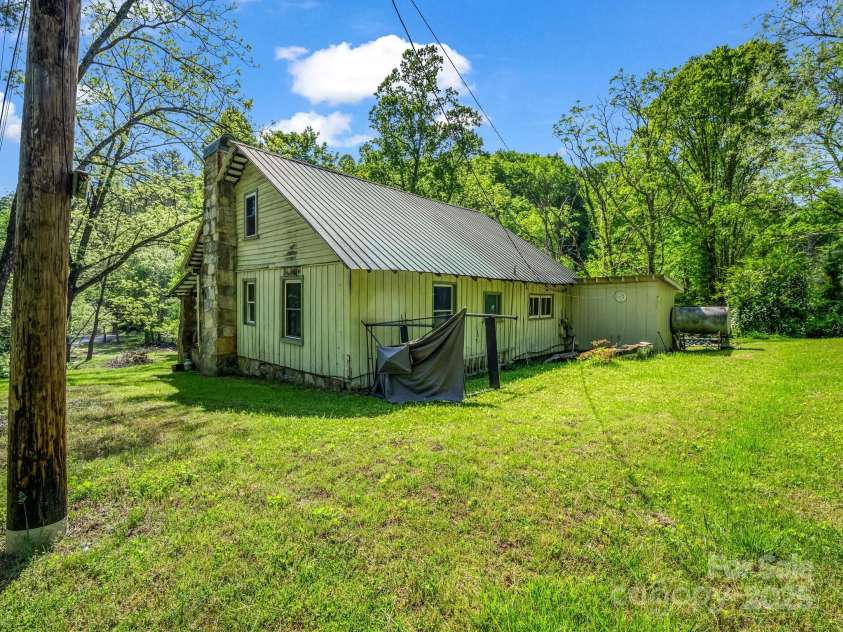 51 Moffitt Road, Horse Shoe, NC 28742.  MLS# CAR4257739, YatesRealty ID 14674. Side and rear of home