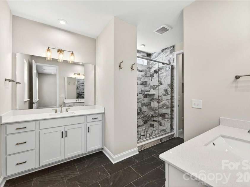 183 Landy Street, Fort Mill, SC 29715.  MLS# CAR4360547, YatesRealty ID 14679. Dual vanity primary bathroom with ample storage