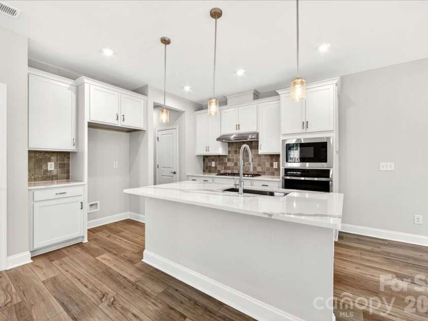 183 Landy Street, Fort Mill, SC 29715.  MLS# CAR4360547, YatesRealty ID 14679. Gourmet Kitchen with white quartz countertops and cabinets