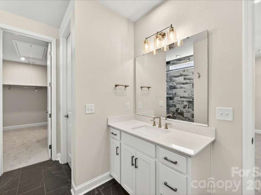 183 Landy Street, Fort Mill, SC 29715.  MLS# CAR4360547, YatesRealty ID 14679. Primary bathroom with access to walk-in closet and laundry room