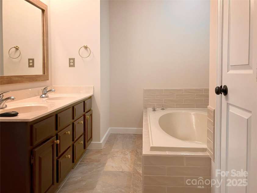 23 Moriah Lane, Asheville, NC 28803.  MLS# CAR4221443, YatesRealty ID 1468. Primary en-suite bathroom with separate bath and shower areas.