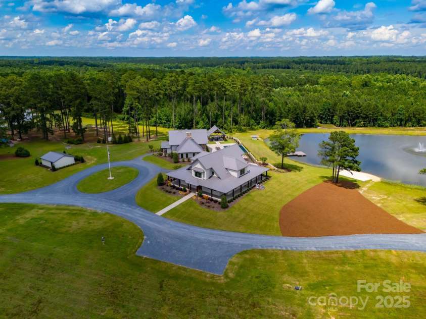 3759 NC 24/27 Highway, Cameron, NC 28326.  MLS# CAR4277323, YatesRealty ID 147. Aerial Of The Guest House, Hunting Lodge, Teams Room, & 2nd Pond.