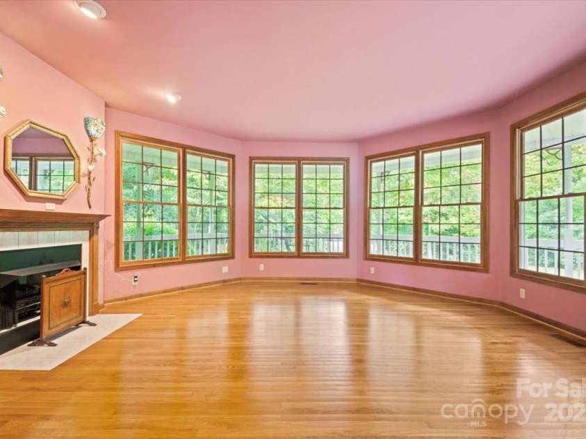 5580 Greenville Highway, Brevard, NC 28712.  MLS# CAR4196657, YatesRealty ID 147. Living room with gas fireplace