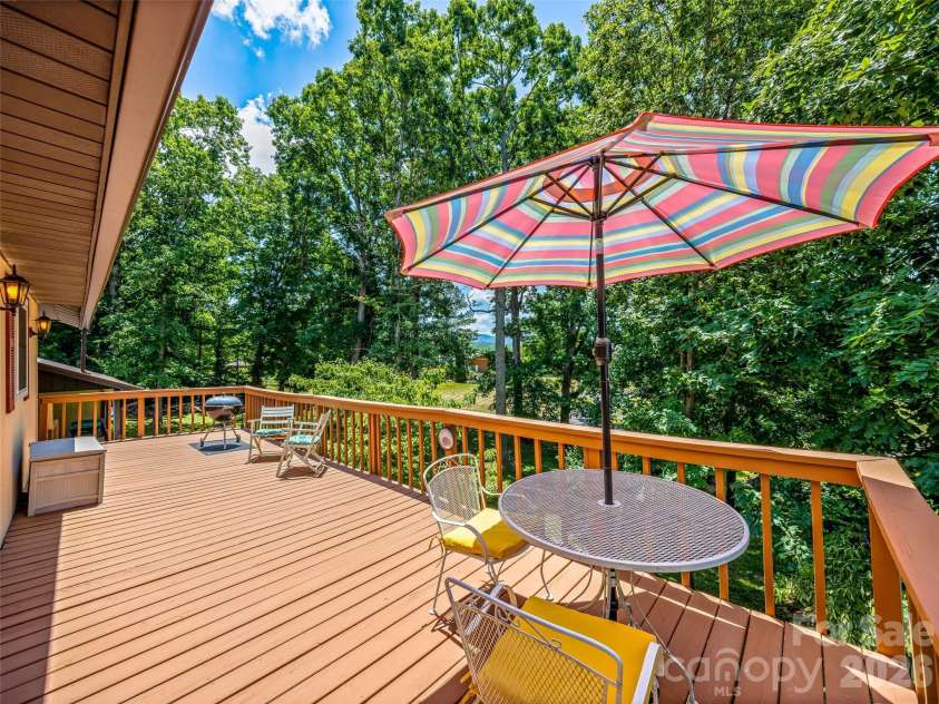 29 Tall Oaks Road, Candler, NC 28715.  MLS# CAR4333653, YatesRealty ID 14716. Roomy back deck invites summertime tranquility