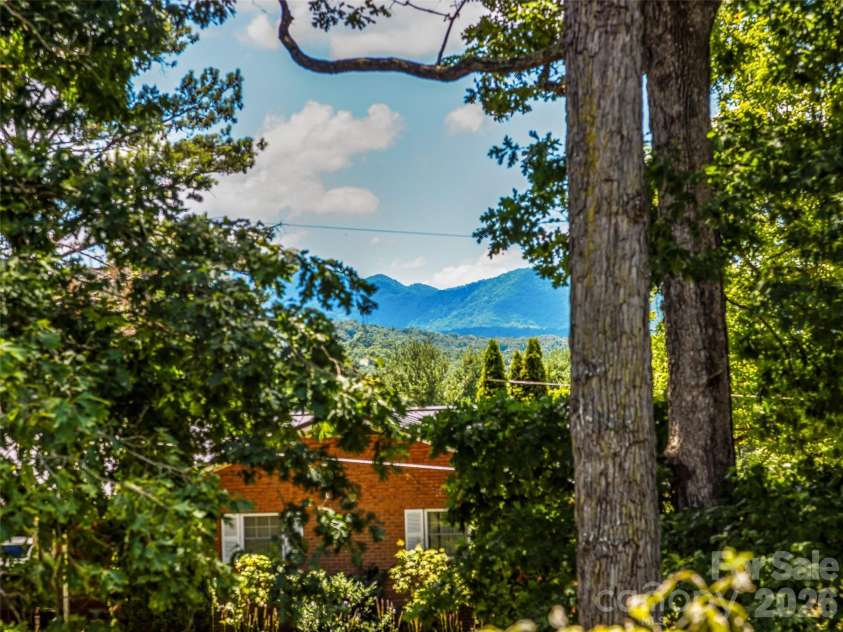 29 Tall Oaks Road, Candler, NC 28715.  MLS# CAR4333653, YatesRealty ID 14716. Summer views from back deck!