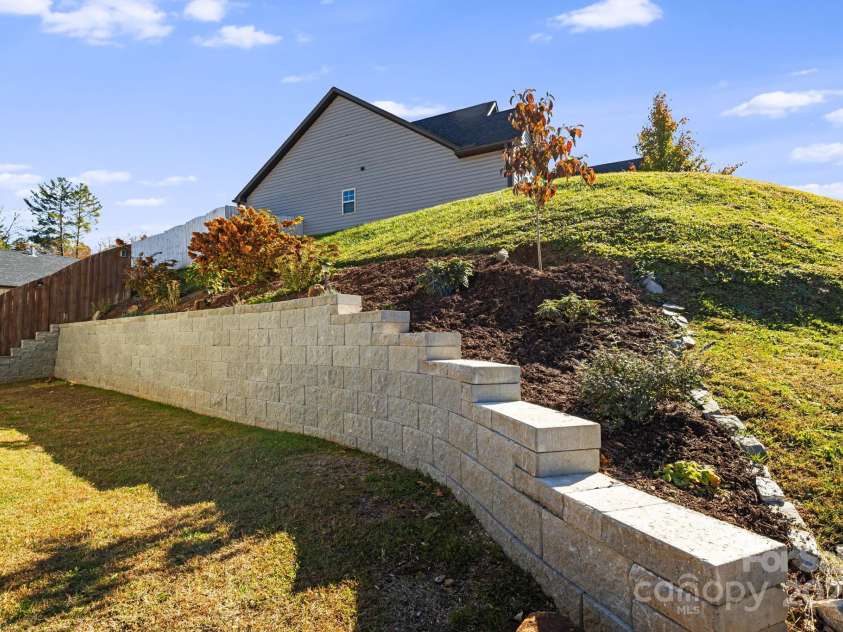 504 Rosebud Orchid Way, Weaverville, NC 28787.  MLS# CAR4318464, YatesRealty ID 14719. Brand new $15K Stone Terrace added in 2024 - Easy step access for gardening. New Dogwood Tree added - The NC State Tree!!