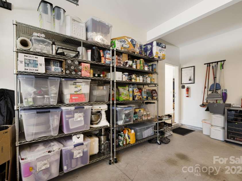 504 Rosebud Orchid Way, Weaverville, NC 28787.  MLS# CAR4318464, YatesRealty ID 14719. Garage metal shelves convey - 2 Car Garage with keypad code access from the driveway