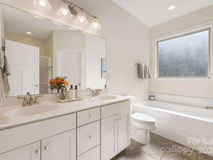 504 Rosebud Orchid Way, Weaverville, NC 28787.  MLS# CAR4318464, YatesRealty ID 14719. Lower Primary Bath with Dual sinks and Soaking Tub (No Jacuzzi Jets)