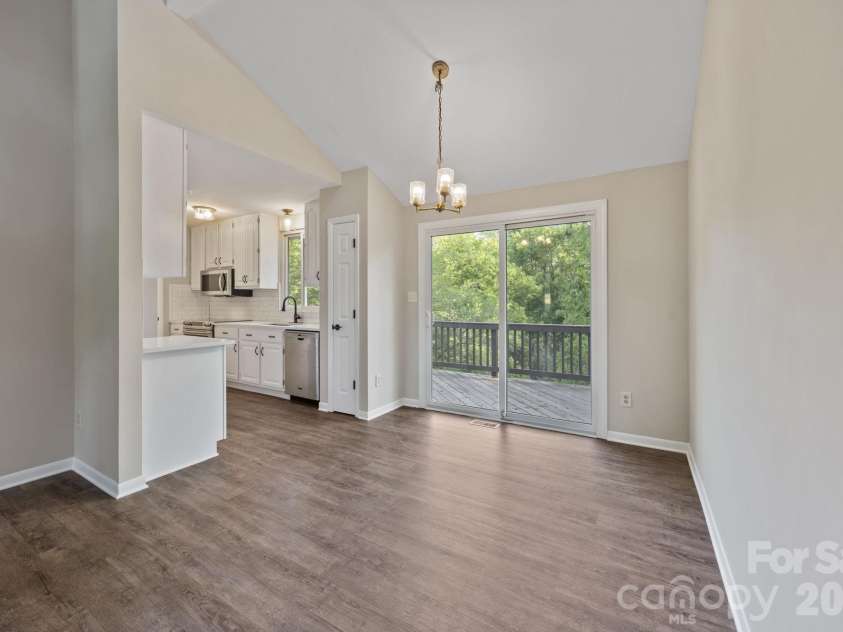 5979 Tall Tree Lane, Harrisburg, NC 28075.  MLS# CAR4370222, YatesRealty ID 14722. Open Living Space with room for a dining table and access to back deck. 