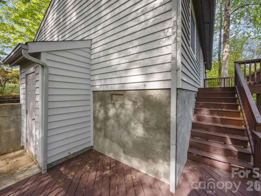 5979 Tall Tree Lane, Harrisburg, NC 28075.  MLS# CAR4370222, YatesRealty ID 14722. Two-tiered deck with stairs leading to walk-in crawlspace/cellar. 