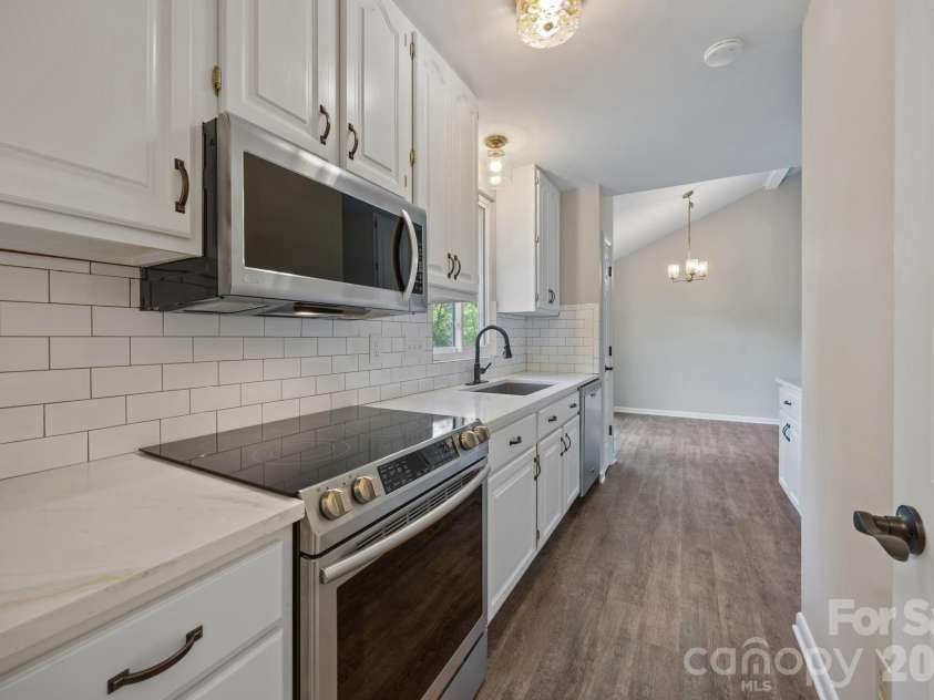 5979 Tall Tree Lane, Harrisburg, NC 28075.  MLS# CAR4370222, YatesRealty ID 14722. View of laundry into kitchen.