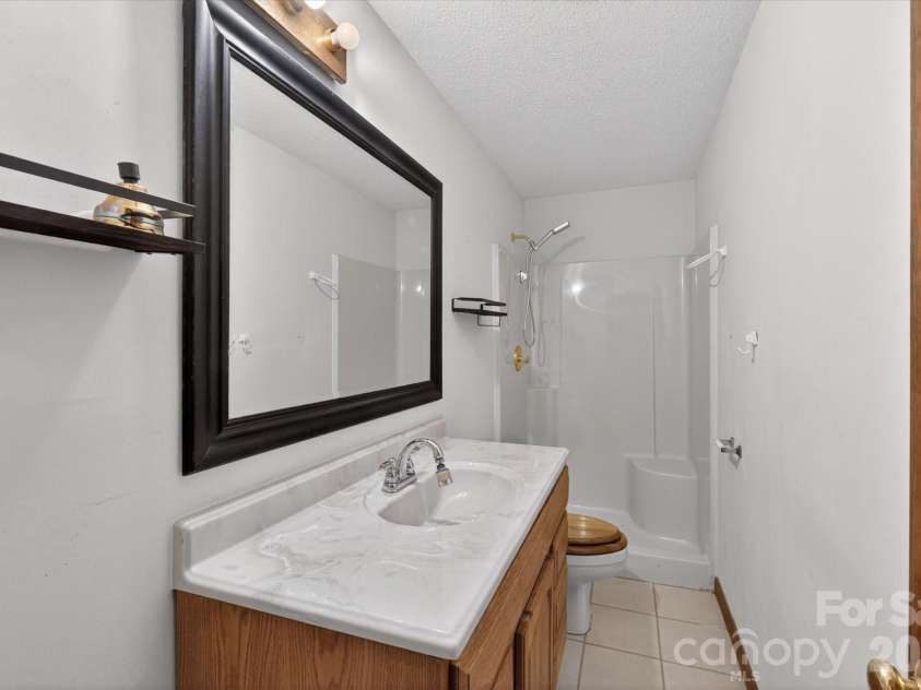 8149 Shannon Woods Lane, Matthews, NC 28104.  MLS# CAR4371130, YatesRealty ID 14728. Basement Bathroom