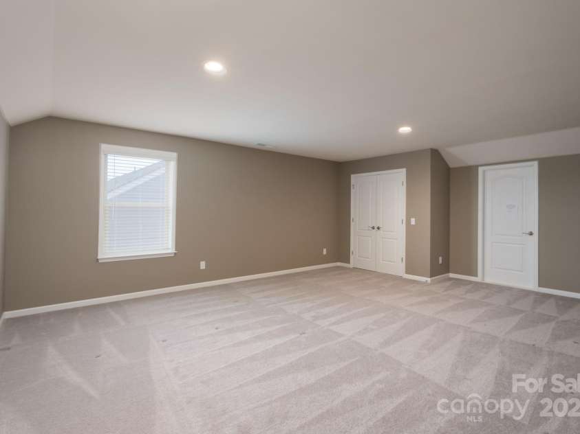 3087 Bartlett Street, Fort Mill, SC 29715.  MLS# CAR4177276, YatesRealty ID 14730. Upper Level Bedroom with Closet and door access to climate controlled Storage