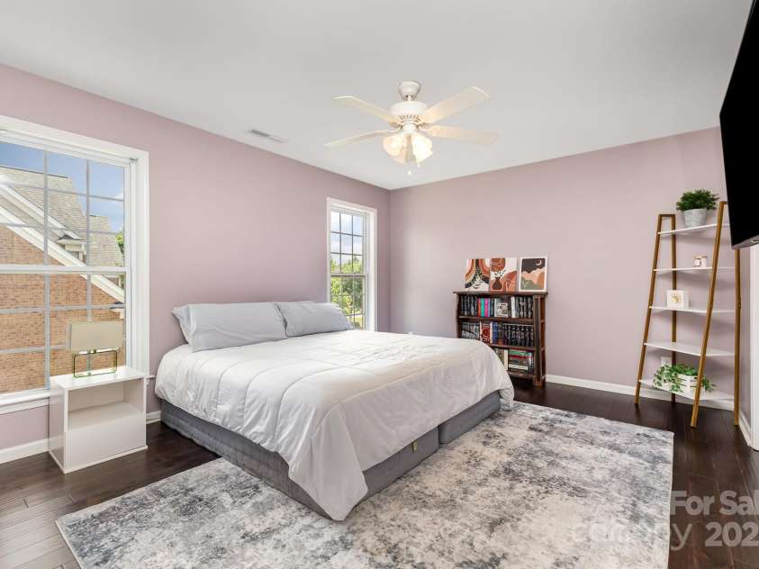 10202 Alouette Drive, Waxhaw, NC 28173.  MLS# CAR4250954, YatesRealty ID 14743. Another roomy secondary bedroom with hardwood flooring, ceiling fan, and big windows