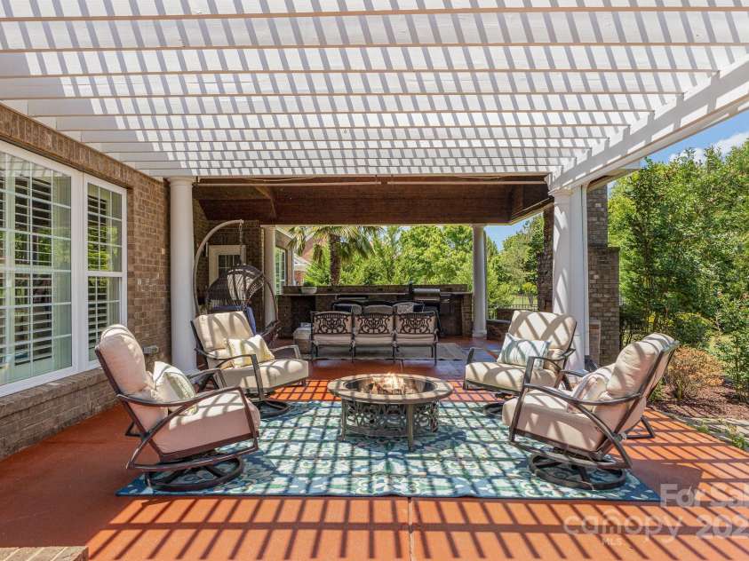 10202 Alouette Drive, Waxhaw, NC 28173.  MLS# CAR4250954, YatesRealty ID 14743. The pergola adds a touch of beauty as you sit around the fire pit with family and friends