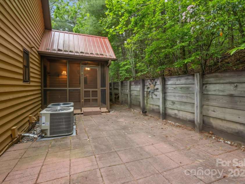 350 Stagecoach Road, Zirconia, NC 28790.  MLS# CAR4262854, YatesRealty ID 14765. Back patio off the screen porch