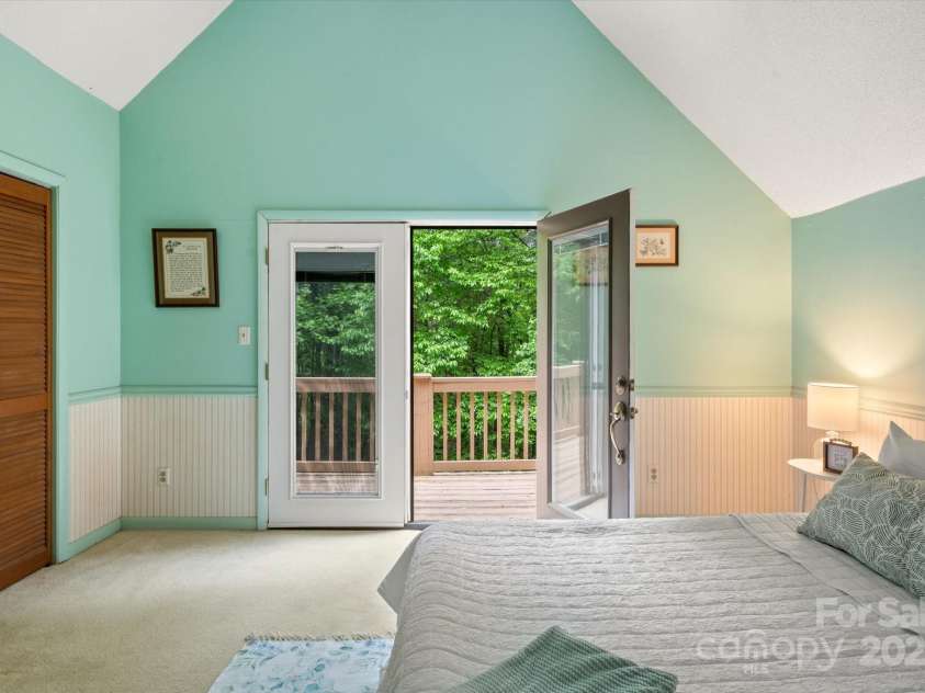 350 Stagecoach Road, Zirconia, NC 28790.  MLS# CAR4262854, YatesRealty ID 14765. Primary Bedroom View 3 Open door to Deck