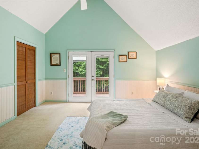 350 Stagecoach Road, Zirconia, NC 28790.  MLS# CAR4262854, YatesRealty ID 14765. Primary Bedroom with doors to deck