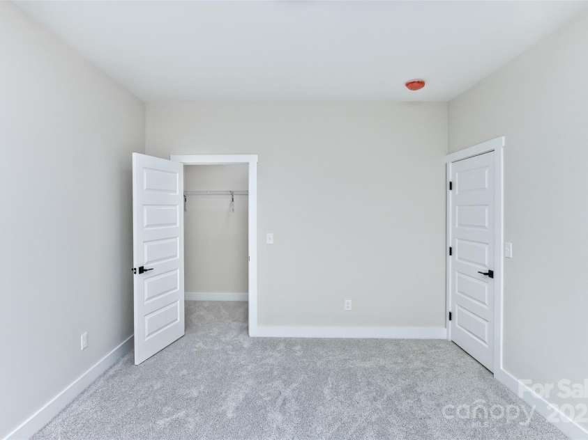 440 Old Buckeye Cove Road, Swannanoa, NC 28778.  MLS# CAR4262695, YatesRealty ID 14766. Bedroom #3 with walk-in closet.