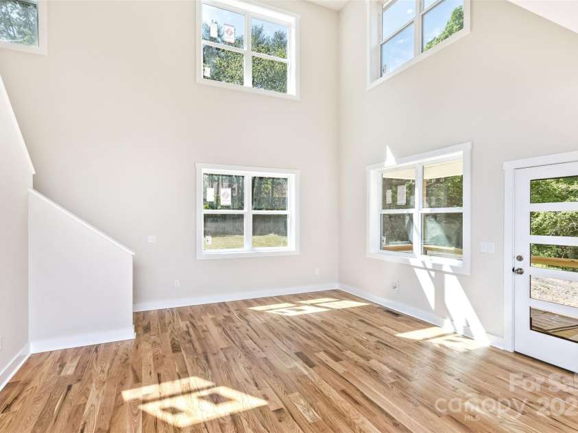 440 Old Buckeye Cove Road, Swannanoa, NC 28778.  MLS# CAR4262695, YatesRealty ID 14766. Enter into a bright living area with vaulted ceilings and gleaming hardwoods!