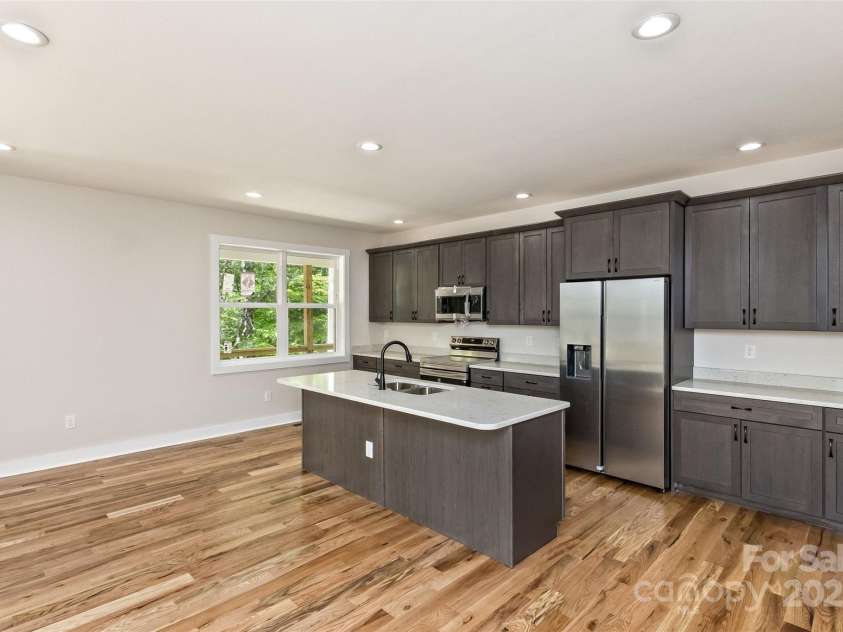 440 Old Buckeye Cove Road, Swannanoa, NC 28778.  MLS# CAR4262695, YatesRealty ID 14766. The center island/bar is full of possibilities w/9 ft ceilings.