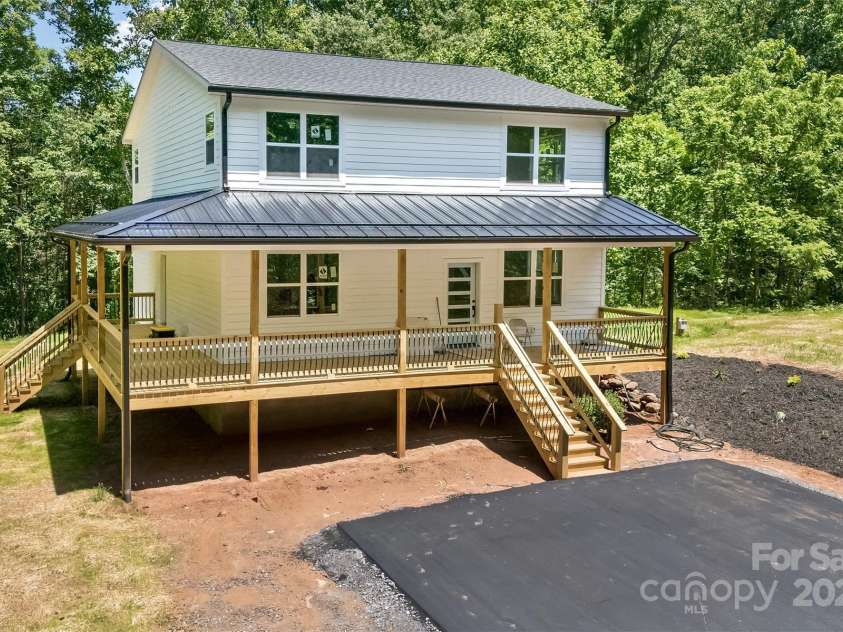 440 Old Buckeye Cove Road, Swannanoa, NC 28778.  MLS# CAR4262695, YatesRealty ID 14766. Ultimate privacy on the rocking chair front porch.