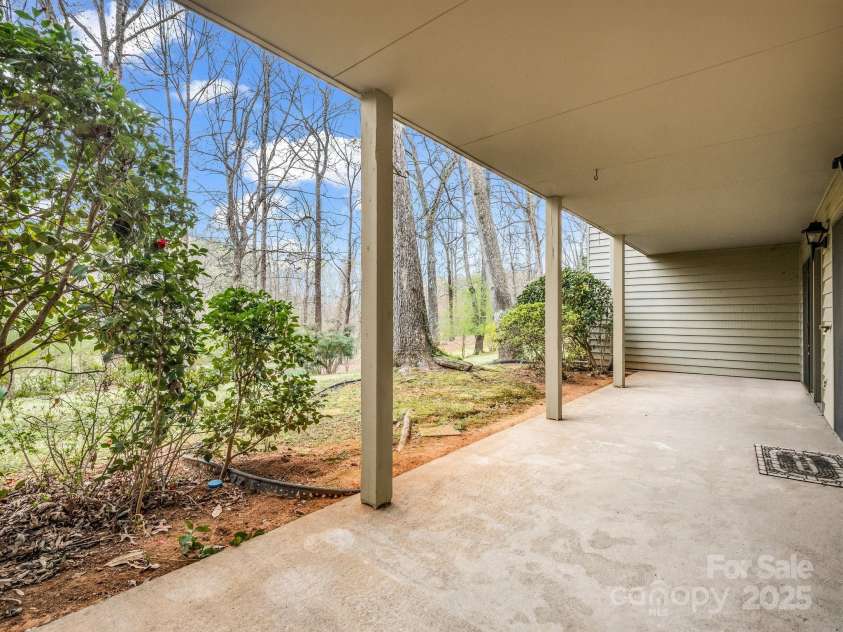 31 Hunting Country Trail, Tryon, NC 28782.  MLS# CAR4240091, YatesRealty ID 14777. Covered patio off basement
