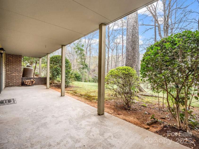 31 Hunting Country Trail, Tryon, NC 28782.  MLS# CAR4240091, YatesRealty ID 14777. Patio off basement 