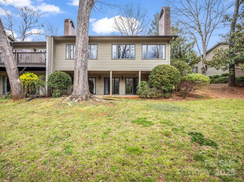 31 Hunting Country Trail, Tryon, NC 28782.  MLS# CAR4240091, YatesRealty ID 14777. Rear View from mostly level yard.