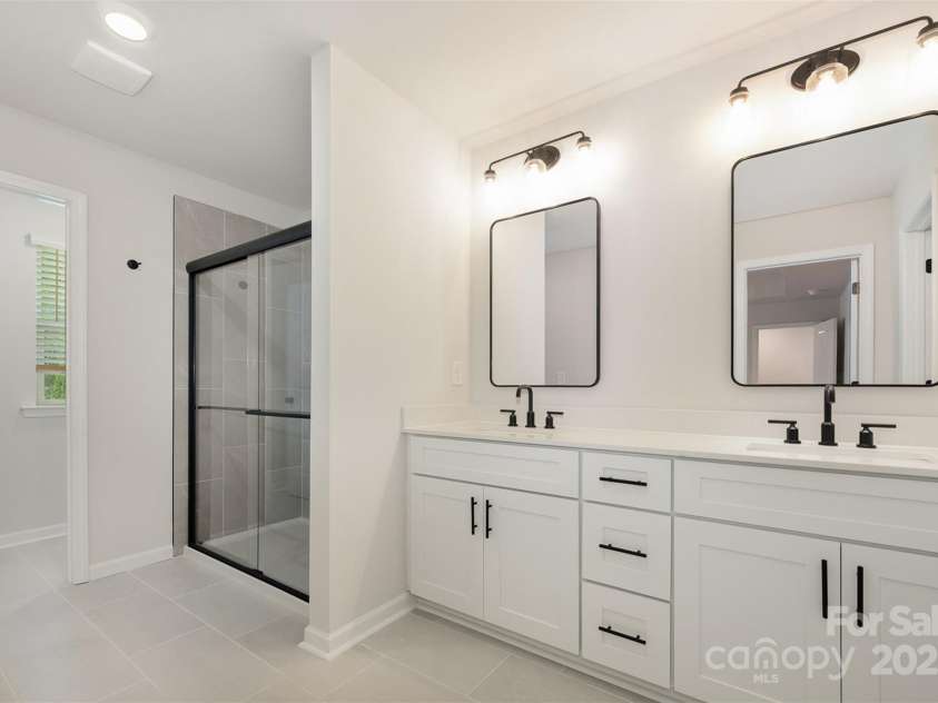 2023 Sadler Woods Lane, Charlotte, NC 28214.  MLS# CAR4263129, YatesRealty ID 14781. Primary bathroom w/ double vanity. Representational Photo.