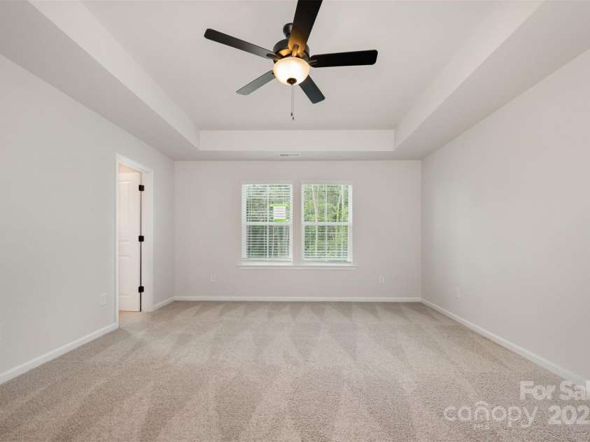 2023 Sadler Woods Lane, Charlotte, NC 28214.  MLS# CAR4263129, YatesRealty ID 14781. Primary bedroom w/ ceiling fan. Representational Photo.