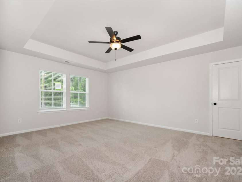 2023 Sadler Woods Lane, Charlotte, NC 28214.  MLS# CAR4263129, YatesRealty ID 14781. Primary bedroom w/ tray ceiling. Representational Photo.