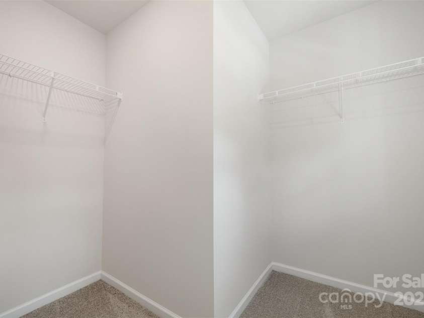 2023 Sadler Woods Lane, Charlotte, NC 28214.  MLS# CAR4263129, YatesRealty ID 14781. Primary suite Walk-in-Closet #1. Representational Photo.